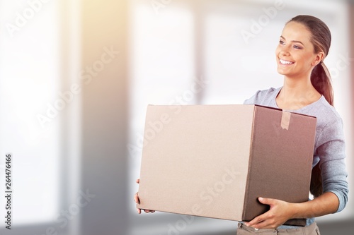 Attractive young woman with box, delivery concept