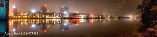 Panorama, foggy view from under the central bridge over the river to cityscape of Umea city, Vasterbotten municipality, Sweden