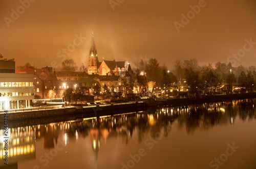 foggy view from the central bridge over the river to the old Umea city church, Vasterbotten municipality, Sweden