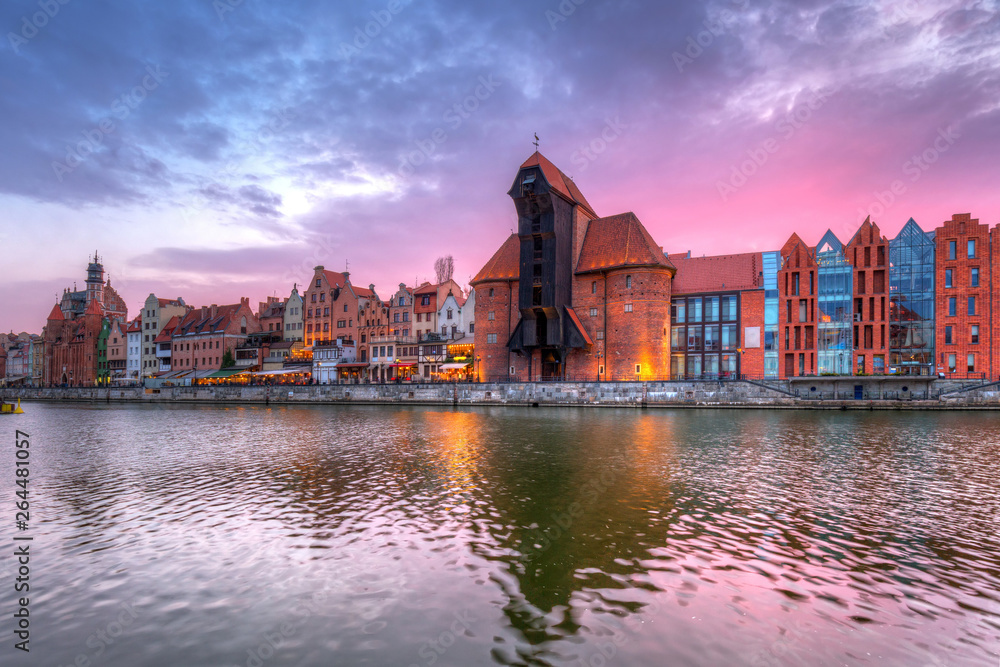 Old town of Gdansk with historic Port crane over Motlawa river at sunset, Poland.