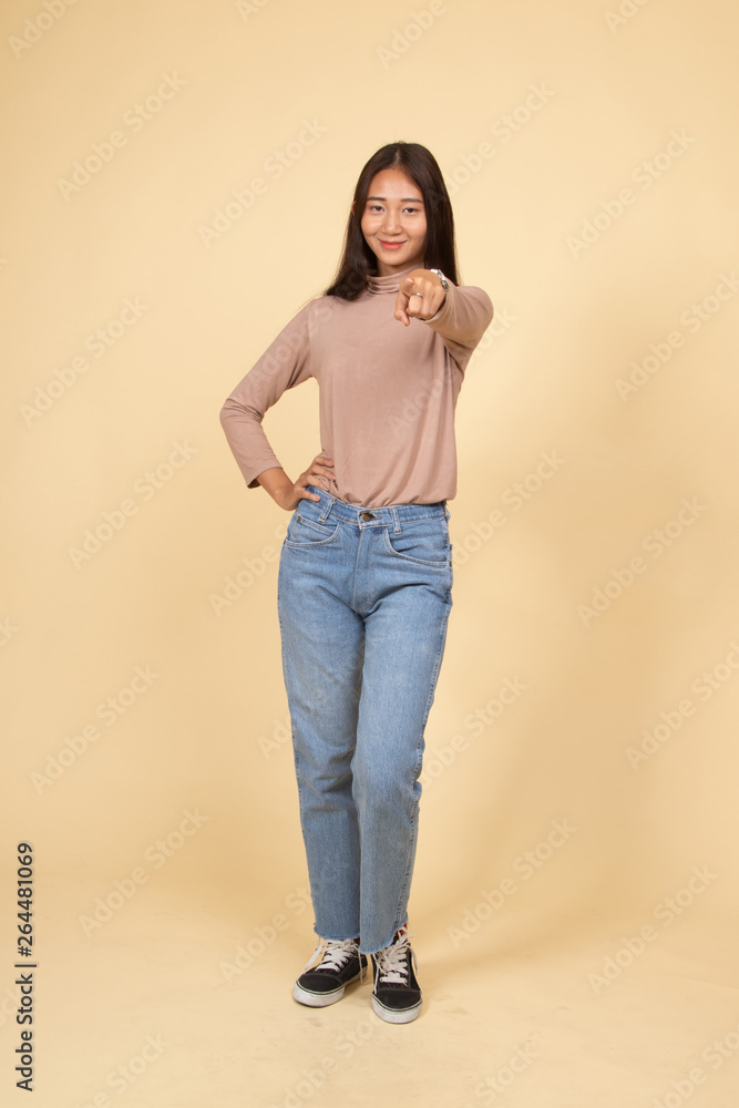 Full body of beautiful young asian woman pointing. Full body of beautiful young asian woman pointing.
