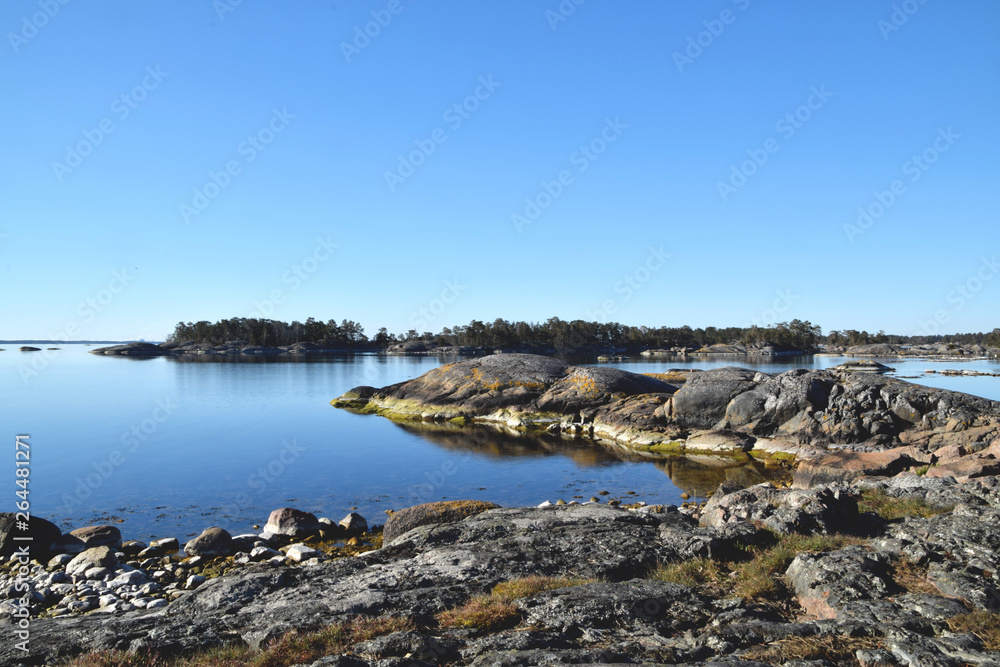 Early morning in the Swedish archipelago wth tranquil water and no boats or people nearby
