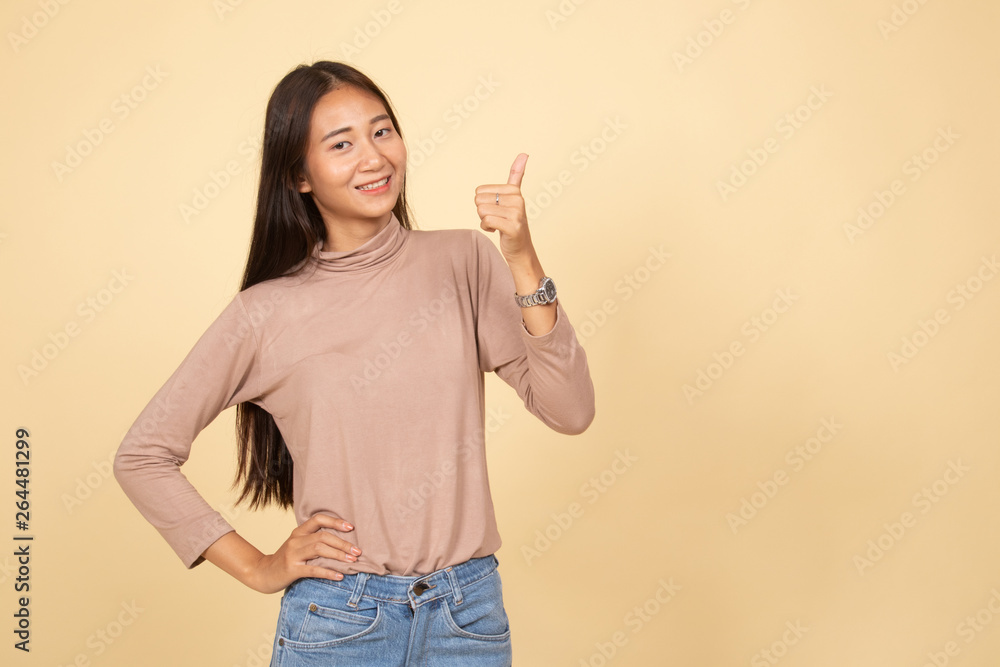 Young Asian woman show thumbs up. Young Asian woman show thumbs up.