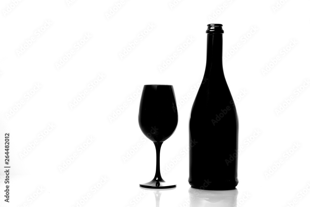 Black champagne bottle with black champagne glass isolated on white background