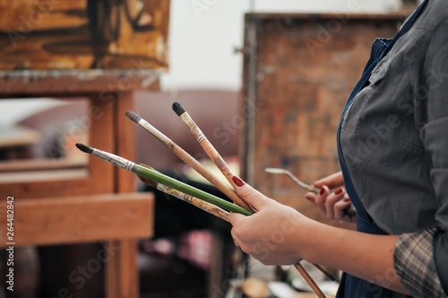Brushes in the hands of the artist's women. Drawing and art.