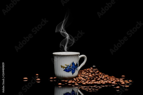 coffe beans and cup on black background