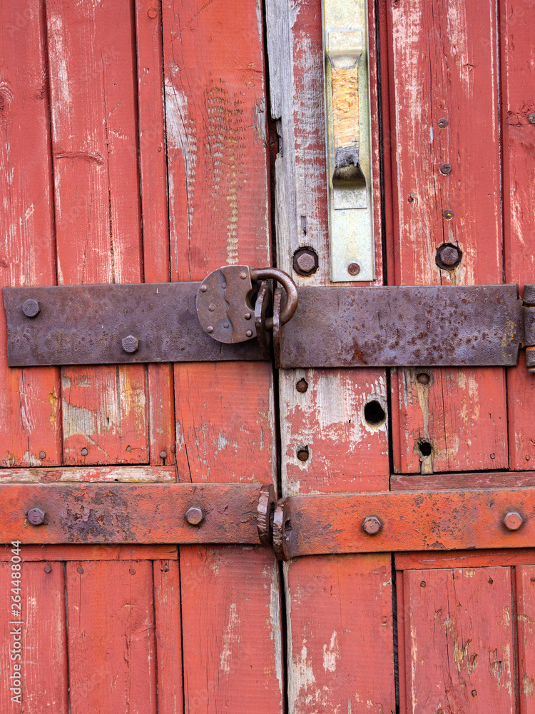 Iron lock hanging on the old wooden gate. Iron lock hanging on the old wooden gate.