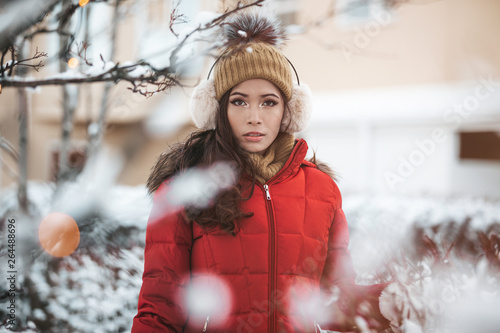 фотографія gorgeous filipino asian girl in her 30s standing out in the snow showing her bea