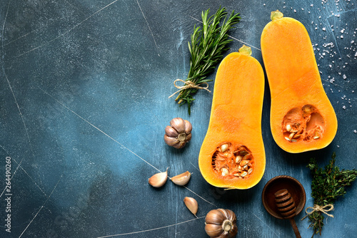 Photos Halves of raw organic butternut squash with ingredients for making