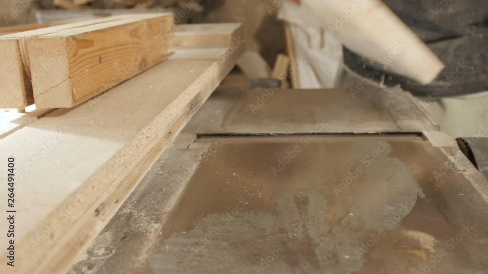 process of sanding a wooden board in a workshop, the hands of man work with wood, grinding the material on a machine, concept skill in construction, hobby process of sanding a wooden board in a workshop, the hands of man work with wood, grinding the material on a machine, concept skill in construction, hobby