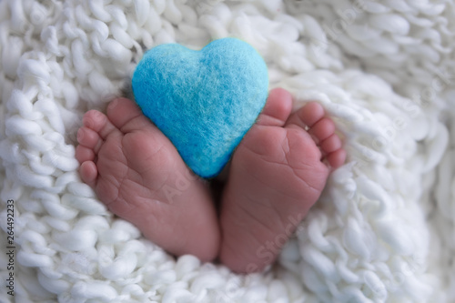 child's legs on white. newborn baby feet. heart in the legs