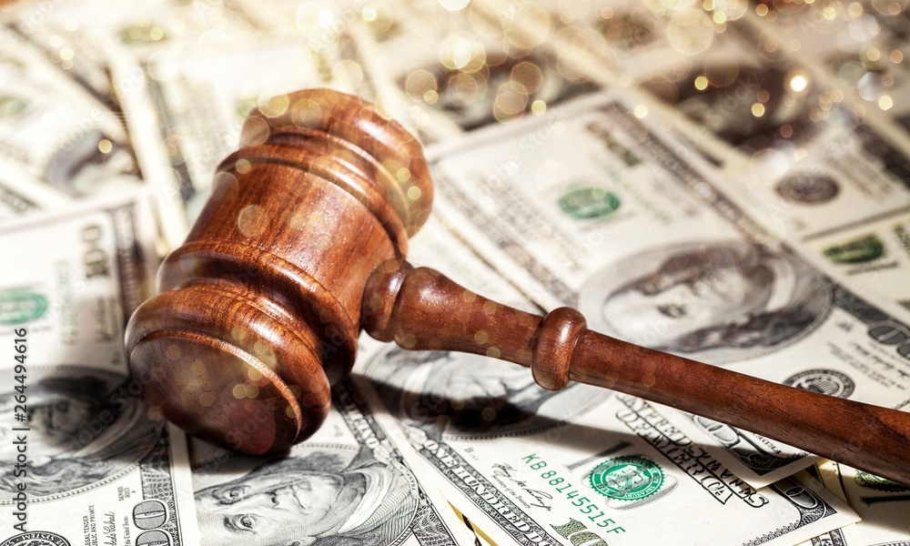Wooden gavel on table and money Wooden gavel on table and money