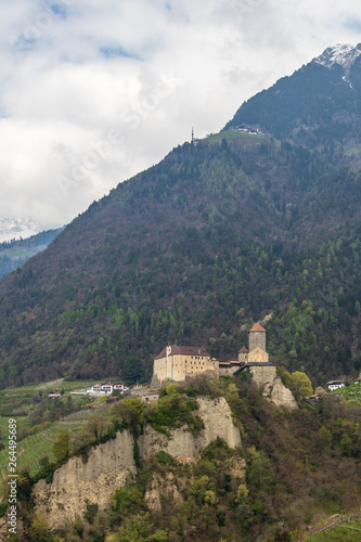 Tyrol Castle in landscape of high mountains. Tirol Village, Province Bolzano, South Tyrol, Italy.