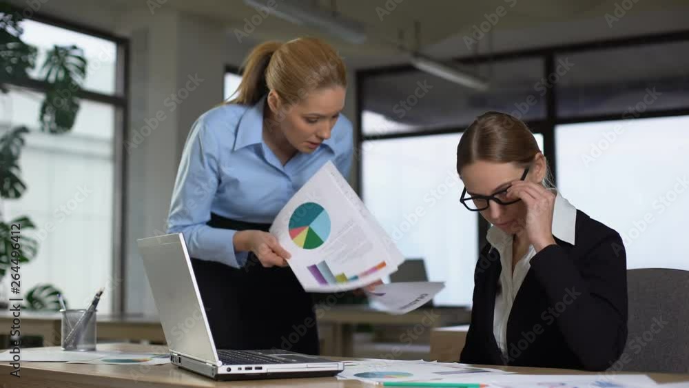 Manager reminding colleague about deadline, angry about charts with low revenues Manager reminding colleague about deadline, angry about charts with low revenues