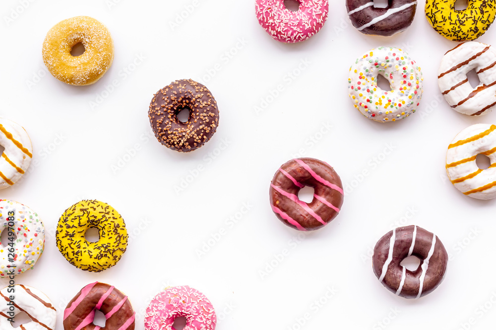 Donuts of different flavors for breakfast on white background top view Donuts of different flavors for breakfast on white background top view