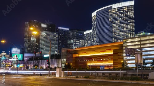Time lapse in motion of Las Vegas Nevada strip hotels and casinos at night with cars and traffic.