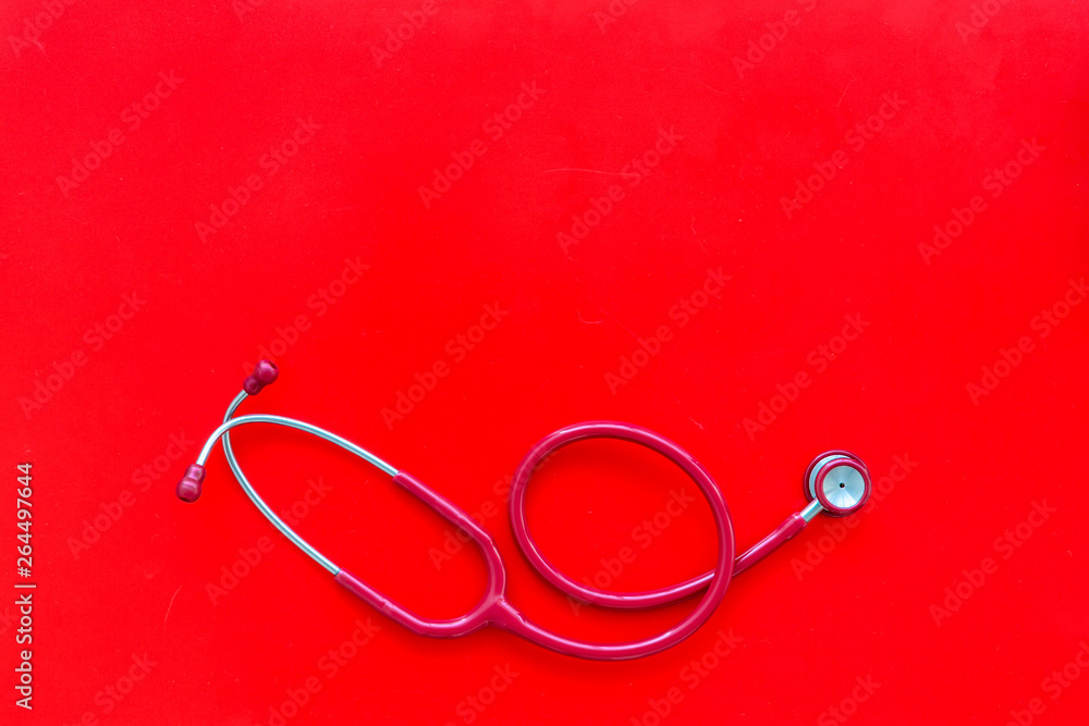Stethoscope for family doctor set on red background top view space for text Stethoscope for family doctor set on red background top view space for text