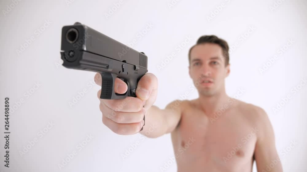 Naked man aims his gun on white background Naked man aims his gun on white background