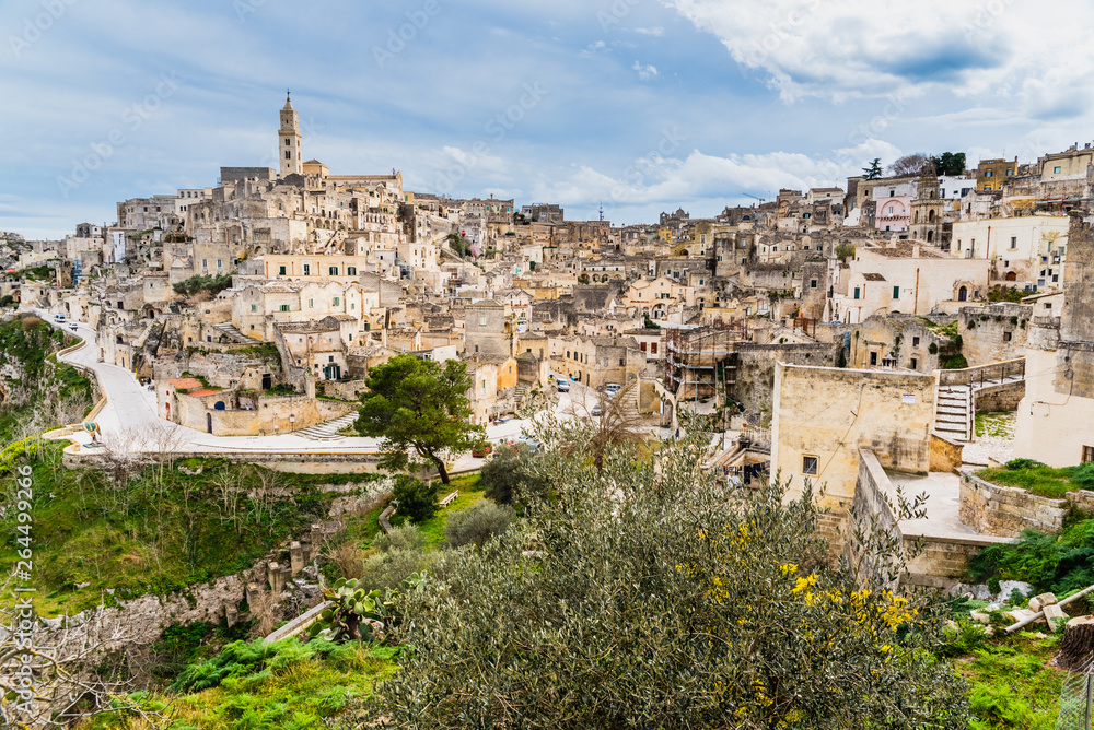 Naklejka premium Long panoramic views of the rocky old town of Matera with its stone roofs.