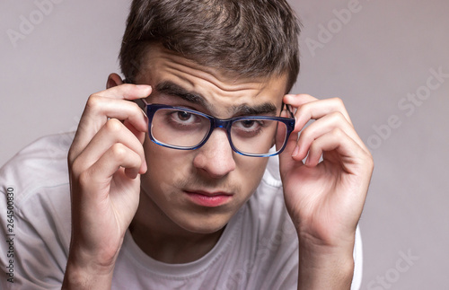 Teenager wearing glasses for sight. Eyesight problems. Health protection concept