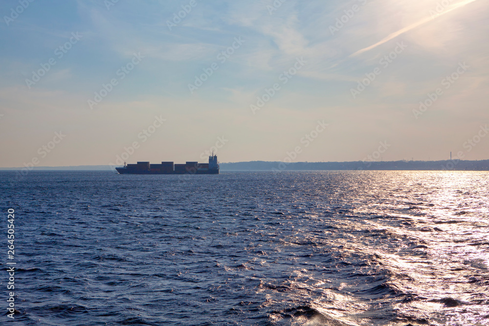 cargo ship on the skyline of blue sea 