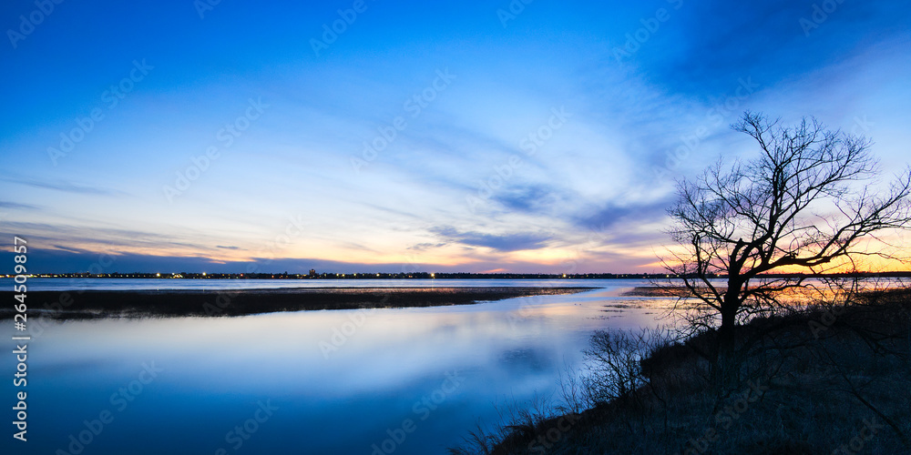 Bemidji, Minnesota, the 2018 Best Town in Minnesota is seen across Lake Bemidji where the Mississippi River flows toward the camera at sunset on a beautiful evening. Bemidji, Minnesota, the 2018 Best Town in Minnesota is seen across Lake Bemidji where the Mississippi River flows toward the camera at sunset on a beautiful evening.
