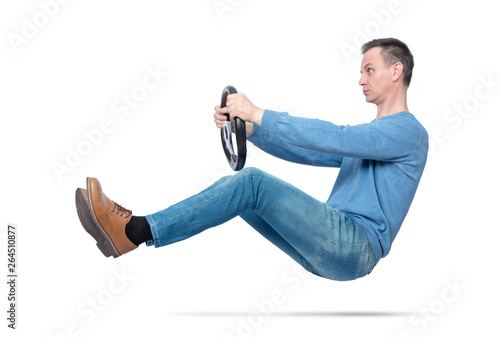 Man in blue casual wear drives a car with a steering wheel, isolated on white background. Auto driver concept 