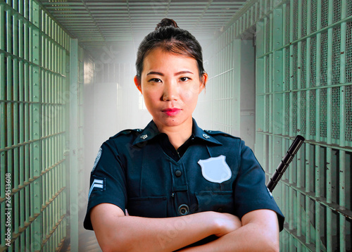 Принти на полотні young serious and attractive Asian Korean guard woman standing on cell at State