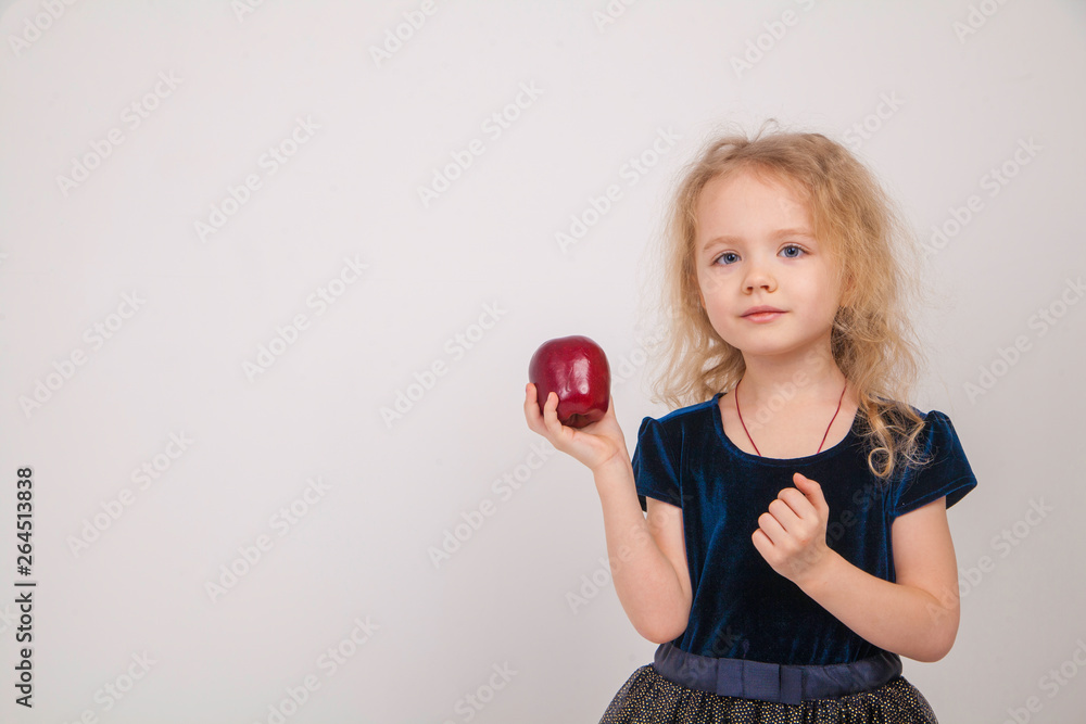 Portrait of beautiful curly little girl holding red apple over white background Portrait of beautiful curly little girl holding red apple over white background