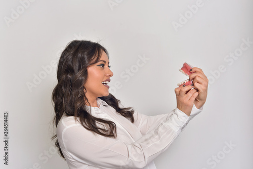Young woman with white shirt in a dental office.