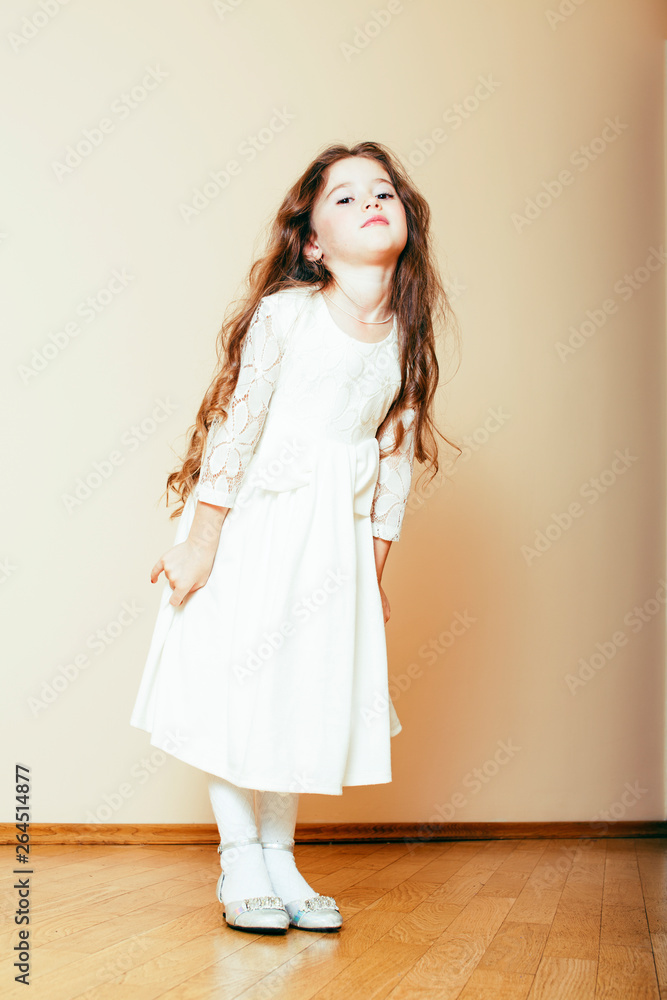 little cute girl with long curly hair posing cheerful on white background, lifestyle people concept little cute girl with long curly hair posing cheerful on white background, lifestyle people concept