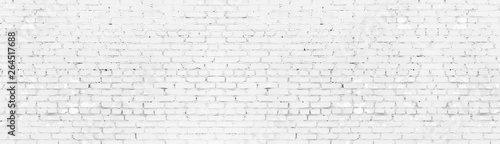 Whitewashed shabby brick wall wide panoramic texture. White painted old brickwork panorama. Long light background
