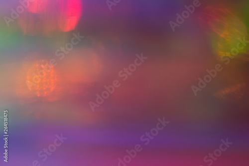 Blurred pink and purple abstract lens flare background. Defocused glow effect. Illuminated bokeh