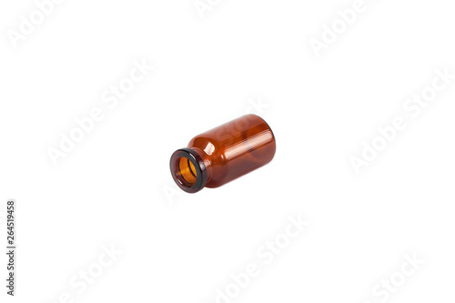 Lying glass vial of brown on white isolated background