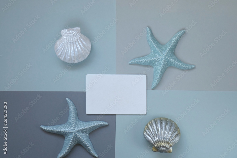 Summer season concept. Summer time. Rest sea.Summer Mockup.Sea Mockup..White frame for text with sea symbols and seashells on a on combined geometric gray background.top view, copy space. Summer season concept. Summer time. Rest sea.Summer Mockup.Sea Mockup..White frame for text with sea symbols and seashells on a on combined geometric gray background.top view, copy space.