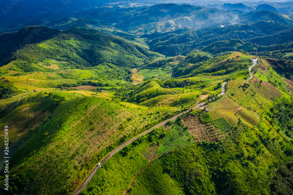 aerial view road way on the green mountain peak in the rain season morning time aerial view road way on the green mountain peak in the rain season morning time