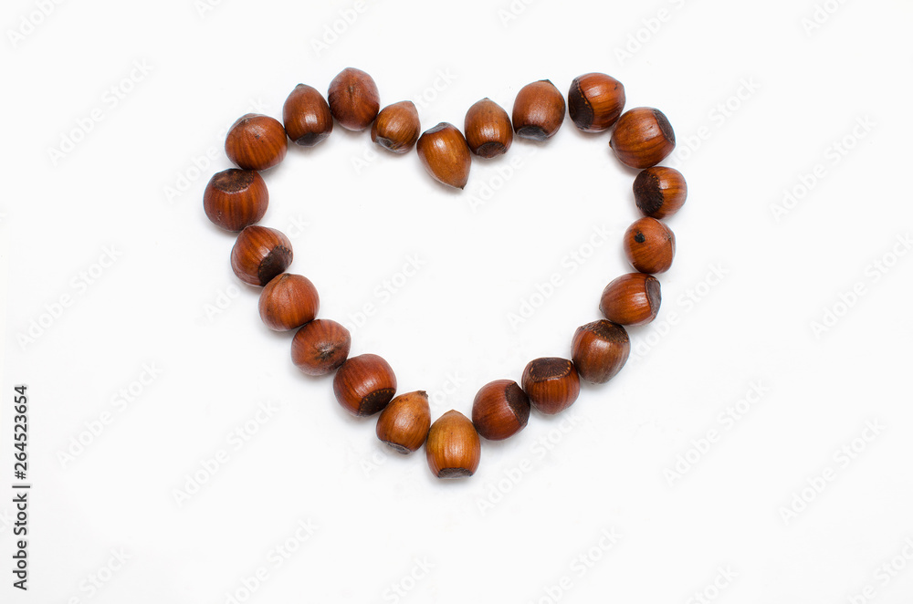 the heart is lined with hazelnut on white background, with a place for the text 