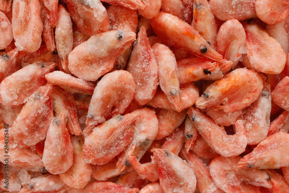 Raw shrimp background. Pile of frozen shrimps on white background.Close-up of frozen shrimps. Shrimp and ice, top view. Raw shrimp background. Pile of frozen shrimps on white background.Close-up of frozen shrimps. Shrimp and ice, top view.