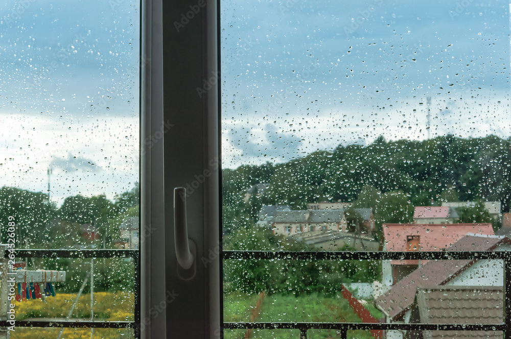 Fototapeta premium The view of rainy weather. Inclement weather outside the window.