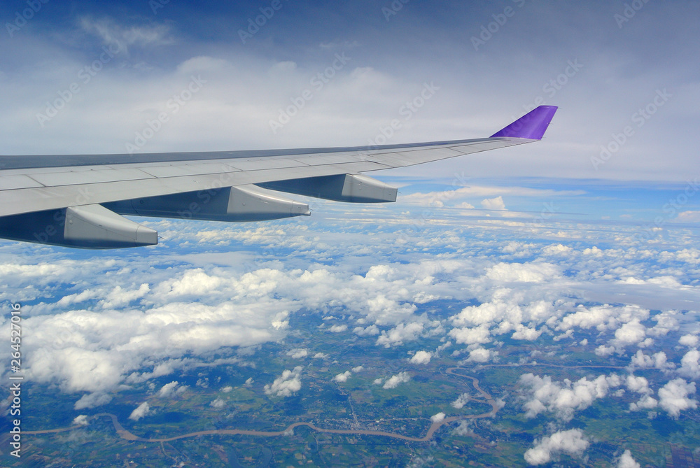 Fototapeta premium Aerial view Clouds and sky as seen through window of an aircraft