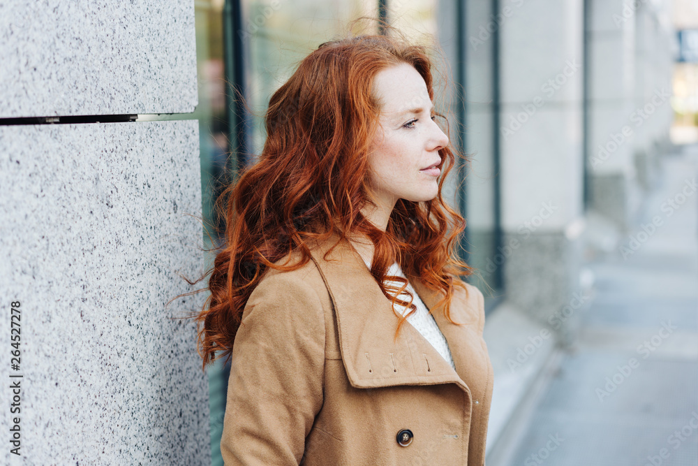 Young stylish redhead woman waiting outdoors Young stylish redhead woman waiting outdoors