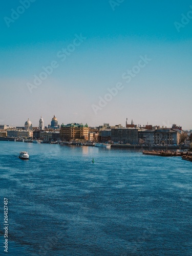 Neva river in St. Petersburg, panorama of the city, visible St. Isaac's Cathedral and port extensions