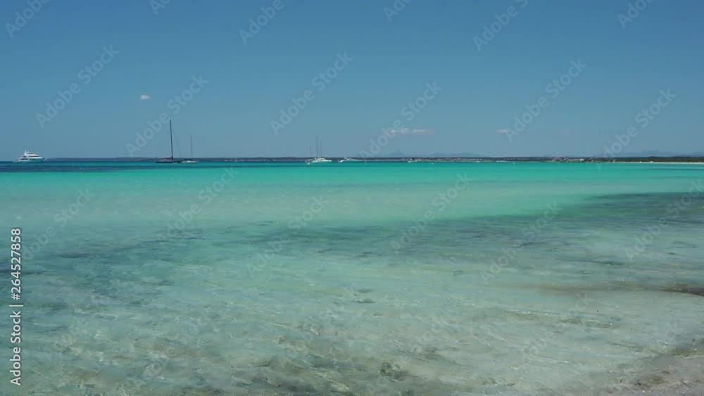Colonia Sant Jordi, Ses Salines, Spain. Amazing view of the boats in turquoise sea close to the charming beach of Es Trenc. It has earned the reputation of Caribbean beach of Mallorca