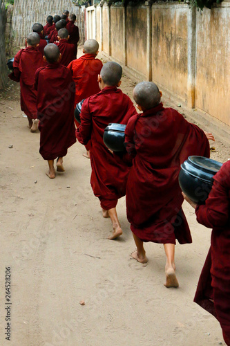 Novice monks recept alms in the historical park of Bagan,Myanmar