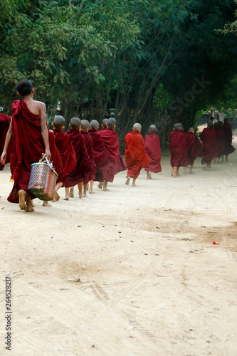 Novice monks recept alms in the historical park of Bagan,Myanmar
