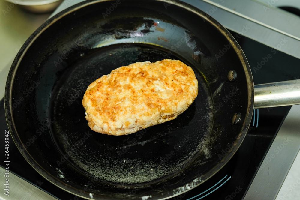 Meat cutlet in the pan.