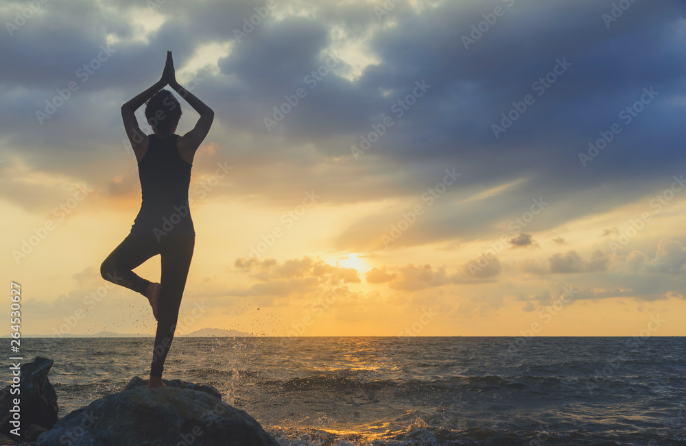 Young woman practicing yoga in the nature.female happiness. Seascape background