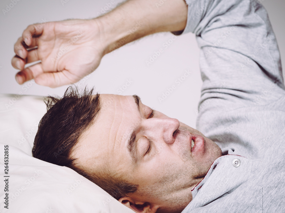 Man waking up in bed Man waking up in bed