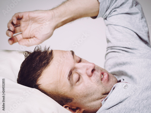 Man waking up in bed