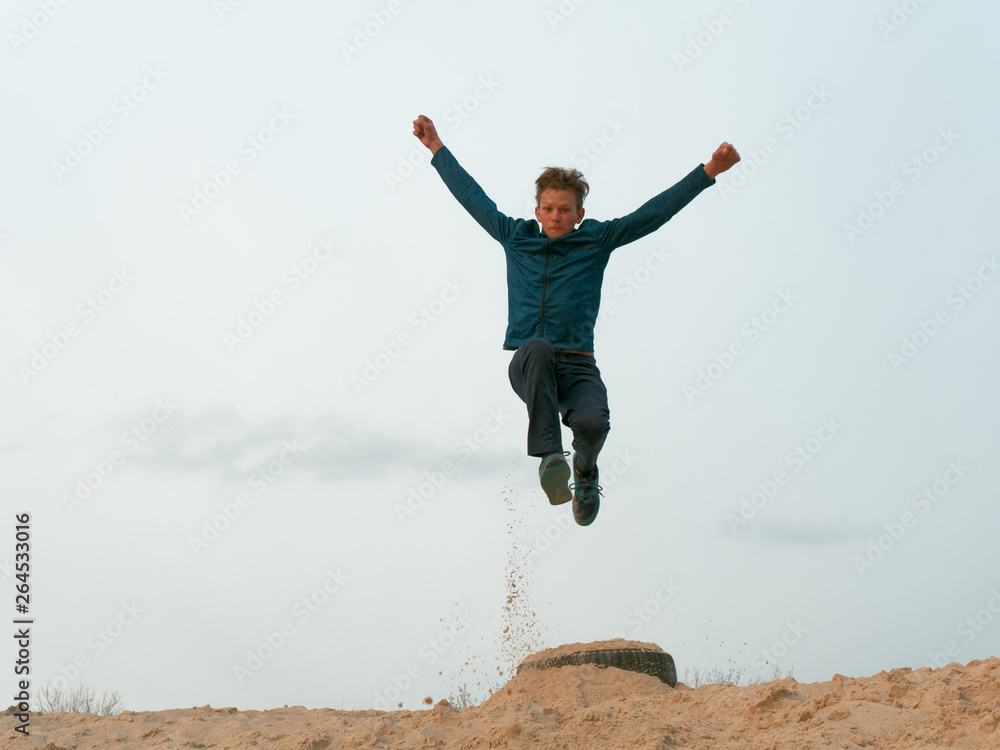 Children and teenagers have fun on the white sand. parkour Children and teenagers have fun on the white sand. parkour